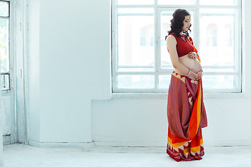 Image showing The pregnant woman belly with henna tattoo