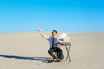 Image showing Businessman using  laptop in a desert