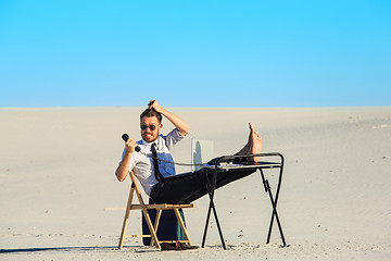 Image showing Businessman using  laptop in a desert