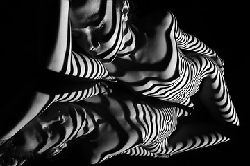 Image showing The nude woman with black and white zebra stripes