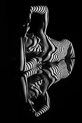 Image showing The nude woman with black and white zebra stripes