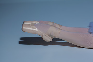 Image showing legs of the ballerina in ballet  pointes on blue background