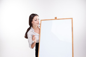 Image showing young business woman showing blank signboard on white background