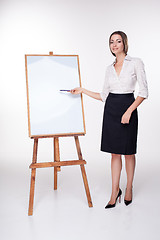 Image showing young business woman showing something on the white background