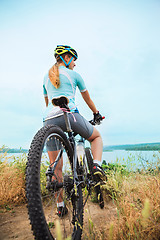 Image showing Young girl riding bicycle outside. Healthy Lifestyle.