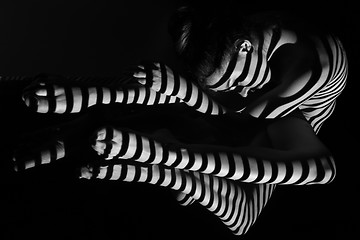 Image showing The nude woman with black and white zebra stripes