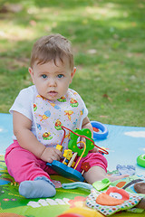 Image showing Baby, less than a year old   playing with  toy 