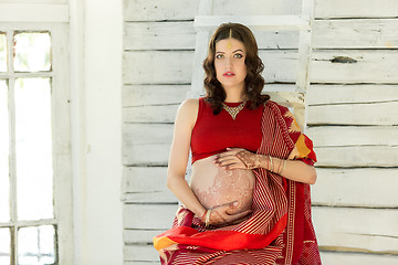 Image showing The pregnant woman belly with henna tattoo