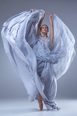 Image showing The beautiful ballerina dancing in blue long dress 