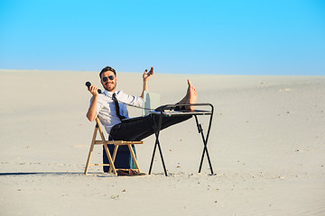 Image showing Businessman using  laptop in a desert