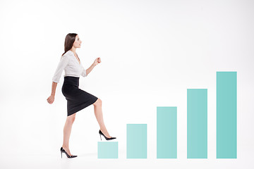 Image showing Young businesswoman walking up on stairs