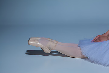 Image showing legs of the ballerina in ballet  pointes on blue background