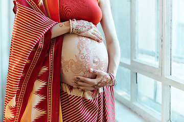 Image showing The pregnant woman belly with henna tattoo