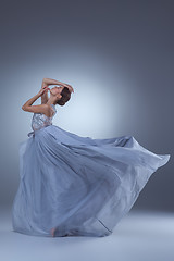 Image showing The beautiful ballerina dancing in blue long dress 