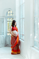 Image showing The pregnant woman belly with henna tattoo