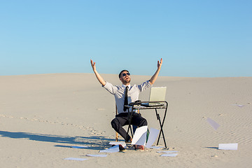 Image showing Businessman using  laptop in a desert