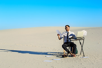 Image showing Businessman using  laptop in a desert