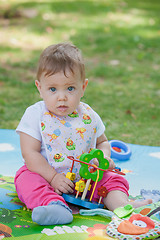 Image showing Baby, less than a year old   playing with  toy 