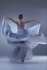 Image showing The beautiful ballerina dancing in blue long dress 