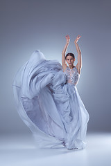 Image showing The beautiful ballerina dancing in blue long dress 