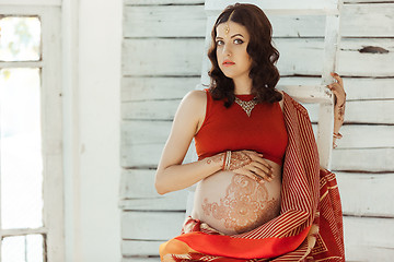 Image showing The pregnant woman belly with henna tattoo