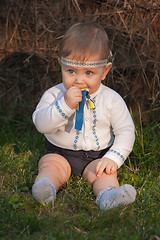 Image showing Baby girl, less than a year old on green grass 