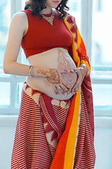 Image showing The pregnant woman belly with henna tattoo