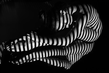 Image showing The nude woman with black and white zebra stripes