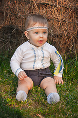 Image showing Baby girl, less than a year old on green grass 