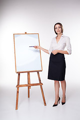 Image showing young business woman showing something on the white background