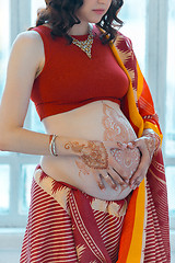 Image showing The pregnant woman belly with henna tattoo