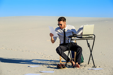 Image showing Businessman using  laptop in a desert