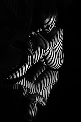 Image showing The nude woman with black and white zebra stripes