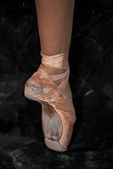 Image showing The close-up  foot of young ballerina in  old pointe shoes 