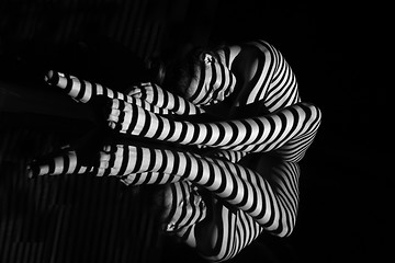 Image showing The nude woman with black and white zebra stripes