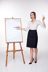 Image showing young business woman showing something on the white background