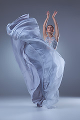 Image showing The beautiful ballerina dancing in blue long dress 