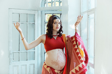 Image showing The pregnant woman belly with henna tattoo