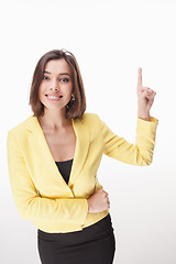 Image showing young business woman showing something on the white background