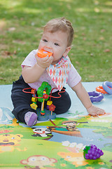 Image showing Baby, less than a year old   playing with  toy 