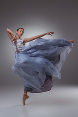 Image showing The beautiful ballerina dancing in blue long dress 