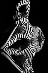 Image showing The nude woman with black and white zebra stripes