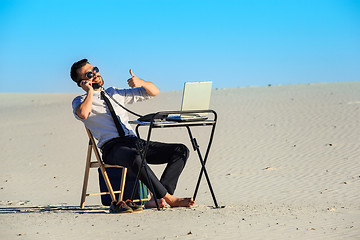 Image showing Businessman using  laptop in a desert