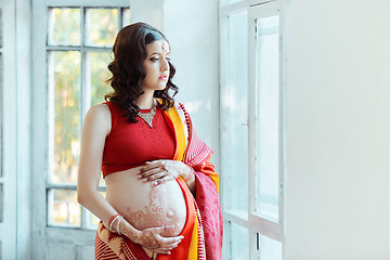 Image showing The pregnant woman belly with henna tattoo