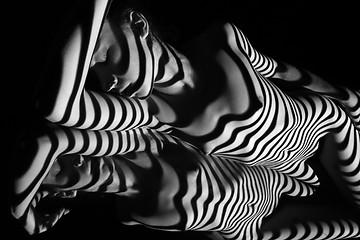 Image showing The nude woman with black and white zebra stripes