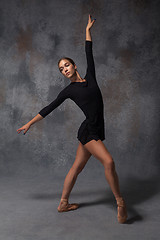 Image showing Young beautiful modern style dancer posing on a studio background