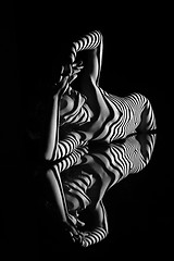 Image showing The nude woman with black and white zebra stripes