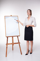 Image showing young business woman showing something on the white background