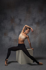 Image showing Young beautiful modern style dancer posing on a studio background