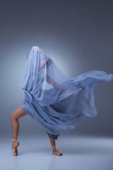 Image showing The beautiful ballerina dancing in blue long dress 